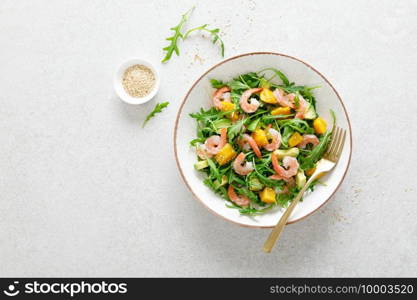Shrimps salad with arugula, mango and avocado. Healthy food concept. Top view