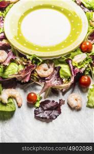shrimps salad with lettuce and tomatoes and empty plate, close up