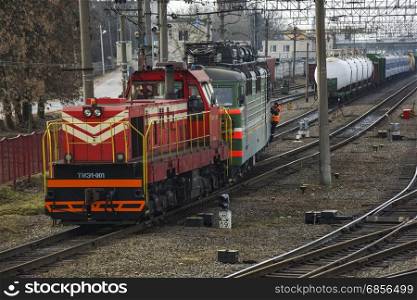 Shunting diesel locomotive pulls the train at the railway yard