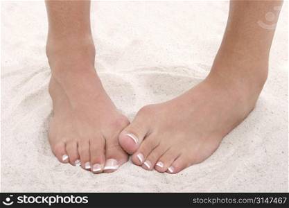 Shy Feet With Pedicure Standing in Sand.