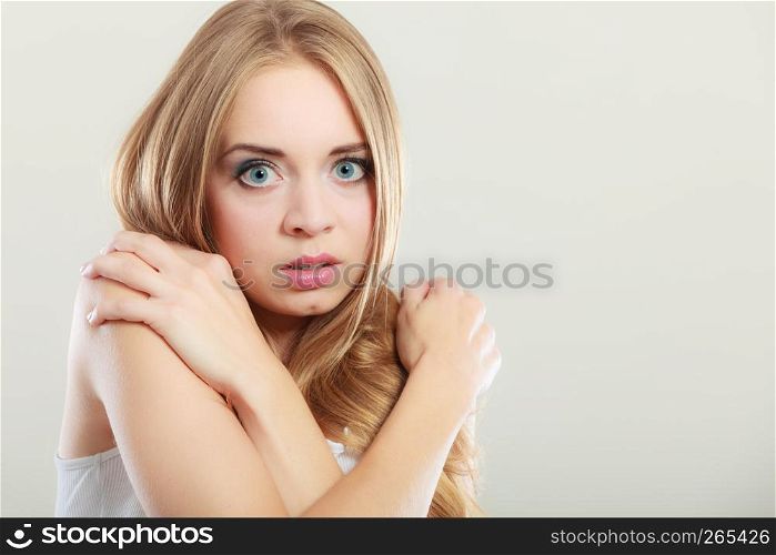 Shy girl, afraid woman on gray background