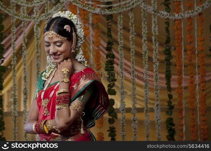 Shy Indian bride looking down and smiling