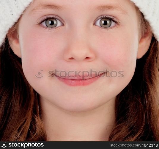 Shy pretty little girl with wool cap smiling