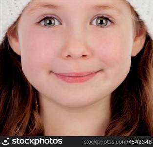 Shy pretty little girl with wool cap smiling