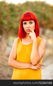 Shy red haired woman with yellow dress