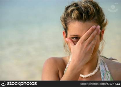 Shy woman at the seaside