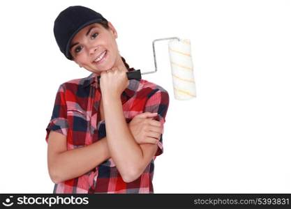 Shy woman holding paint roller