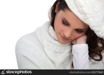 Shy woman wearing hat and jumper