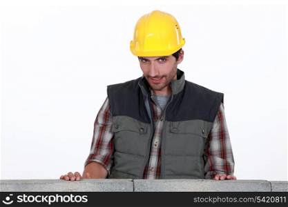 Shy worker behind wall
