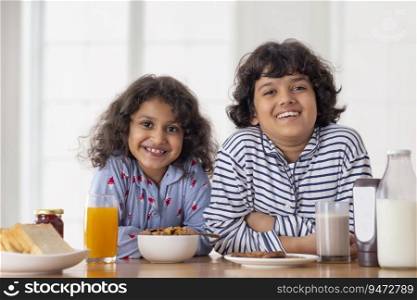 Sibling looking at camera and sitting for breakfast