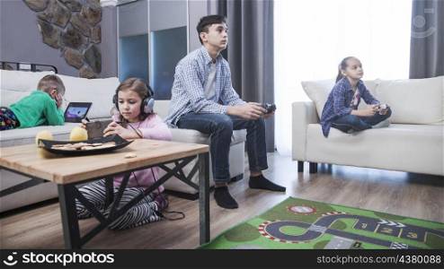 sibling playing video games living room