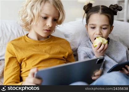 siblings bed playing mobile tablet 4