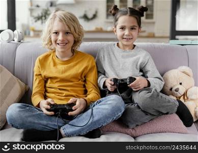siblings couch with joysticks playing