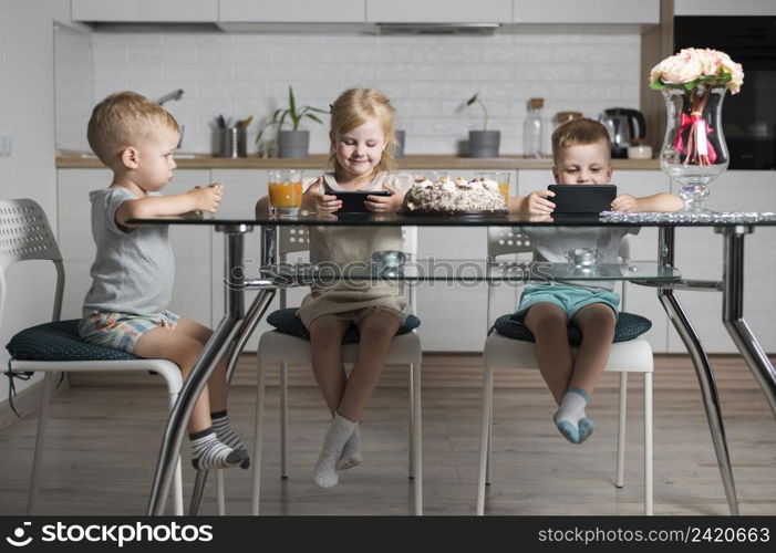 siblings playing with their smart phones