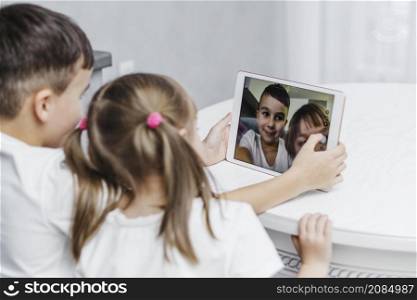 siblings taking self portrait digital tablet
