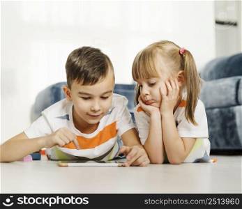 siblings using digital tablet