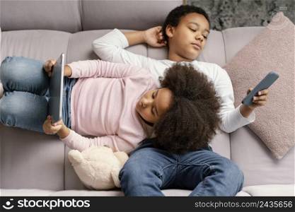siblings using tablet mobile home 2