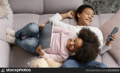 siblings using tablet mobile home 3