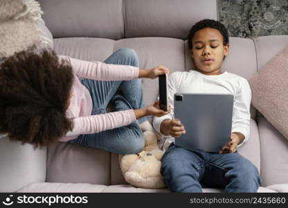 siblings using tablet mobile home 4