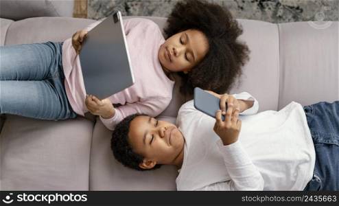 siblings using tablet mobile home 6