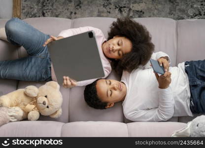 siblings using tablet mobile home 7