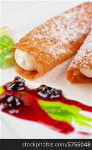 Sicilian cannoli at plate decorated with lime and jam. Sicilian cannoli