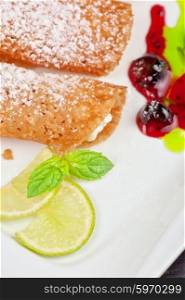 Sicilian cannoli at plate. Sicilian cannoli at plate decorated with lime and jam