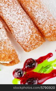 Sicilian cannoli. Sicilian cannoli at plate decorated with lime and jam