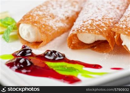 Sicilian cannoli. Sicilian cannoli at plate decorated with lime and jam