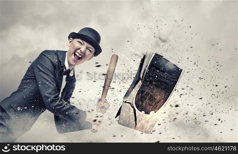 Sick and tired. Young crazy woman damaging computer processor with baseball bat