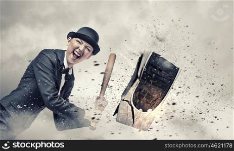 Sick and tired. Young crazy woman damaging computer processor with baseball bat
