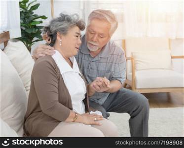 Sick asian senior woman or grandmother is fainted and fallen on floor, grandfather help,care,support of her,elderly people unconscious lying on the ground,concept of dizziness,fainting,losing consciousness