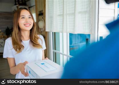 Sick Asian woman hand hold for receive medication first aid pharmacy box from hospital delivery service at front home, merchandise medicine, Delivery man give medicine drug store to patient female