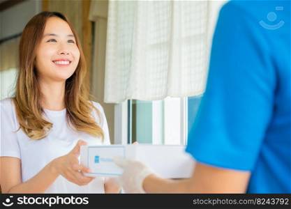 Sick Asian young woman receive medication first aid pharmacy box from hospital delivery service, delivery man give medicine drug to patient female at home, healthcare medicine online concept