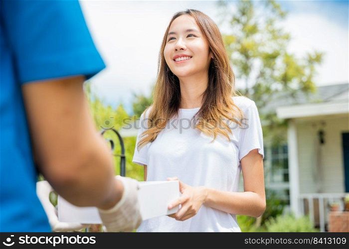 Sick Asian young woman receive medicine first aid pharmacy box from hospital delivery service, happy female receiving patient medicine drug from delivery man, healthcare medicine online concept