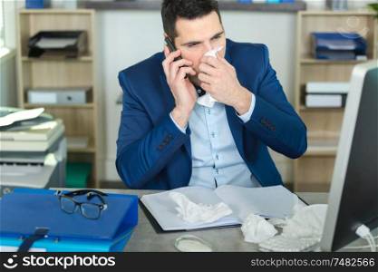sick businessman suffering from illness in the office
