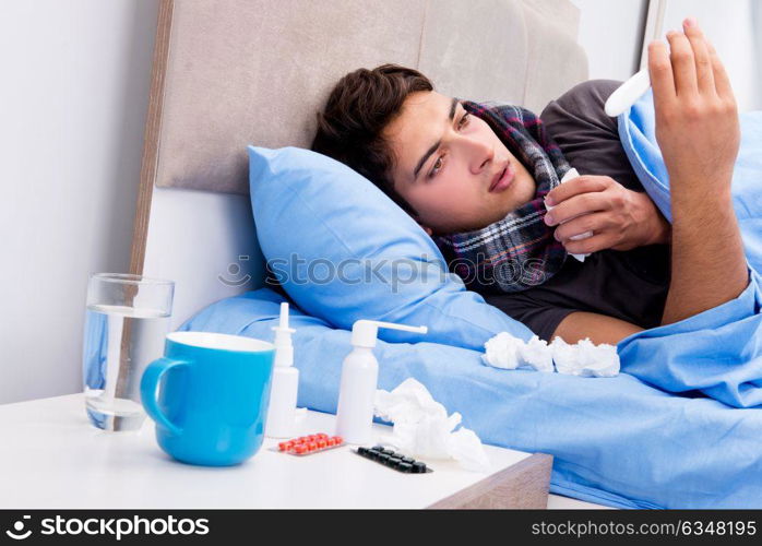 Sick ill man in the bed taking medicines and drugs