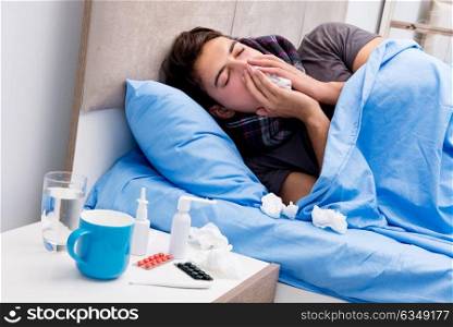 Sick ill man in the bed taking medicines and drugs