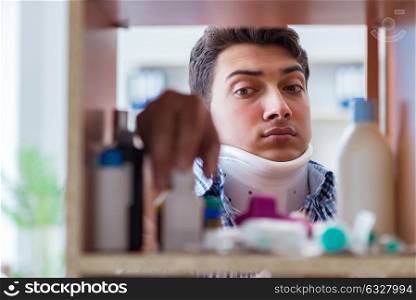 Sick ill man looking for medicines at farmacy shelf. The sick ill man looking for medicines at farmacy shelf