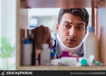 Sick ill man looking for medicines at farmacy shelf