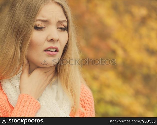 Sick ill woman in autumn park.. Sick woman in fall autumn park. Ill girl caught cold flu outdoor. Rhinitis or allergy. Health care.