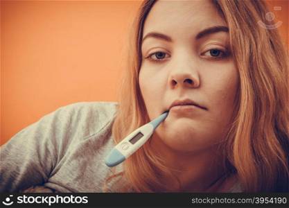 Sick ill woman with digital thermometer in mouth.. Sick ill woman with digital thermometer in mouth. Young girl having high fever measuring temperature. Health. Instagram filter.