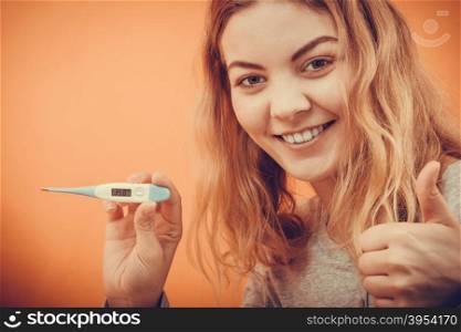 Sick ill woman with digital thermometer showing thumb up gesture. Young girl having high fever measuring temperature. Health.