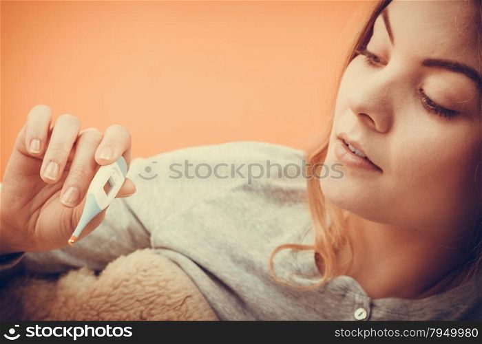 Sick ill woman with digital thermometer.. Sick ill woman with digital thermometer. Young girl having high fever measuring temperature. Health.