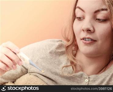 Sick ill woman with digital thermometer. Young girl having high fever measuring temperature. Health.. Sick ill woman with digital thermometer.