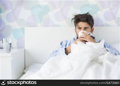Sick man having coffee in bed