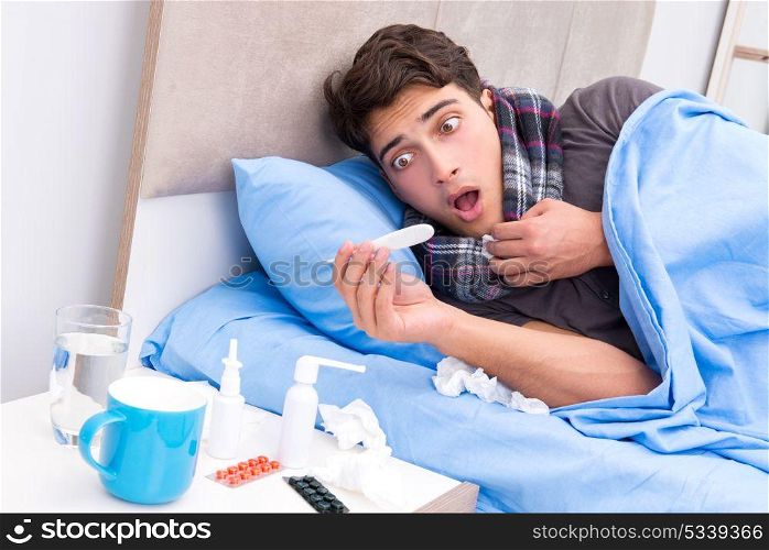 Sick man with flu lying in the bed