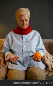 Sick old woman decide what to choose orange or pills. Medical treatment versus organic fruit eating. Sick old woman choose orange or pills