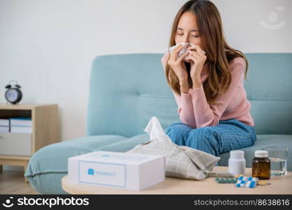 Sick woman. Beautiful female health problem blowing nose use pharmacy kit box delivery service from hospital, delivery pharmacy concept, Asian young girl cold sick she sneeze with tissue paper on sofa