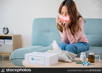 Sick woman. Beautiful female health problem blowing nose use pharmacy kit box delivery service from hospital, delivery pharmacy concept, Asian young girl cold sick she sneeze with tissue paper on sofa